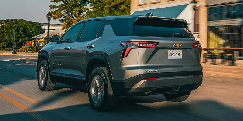 2026 Chevrolet Equinox driving through downtown area in Hillsdale, MI